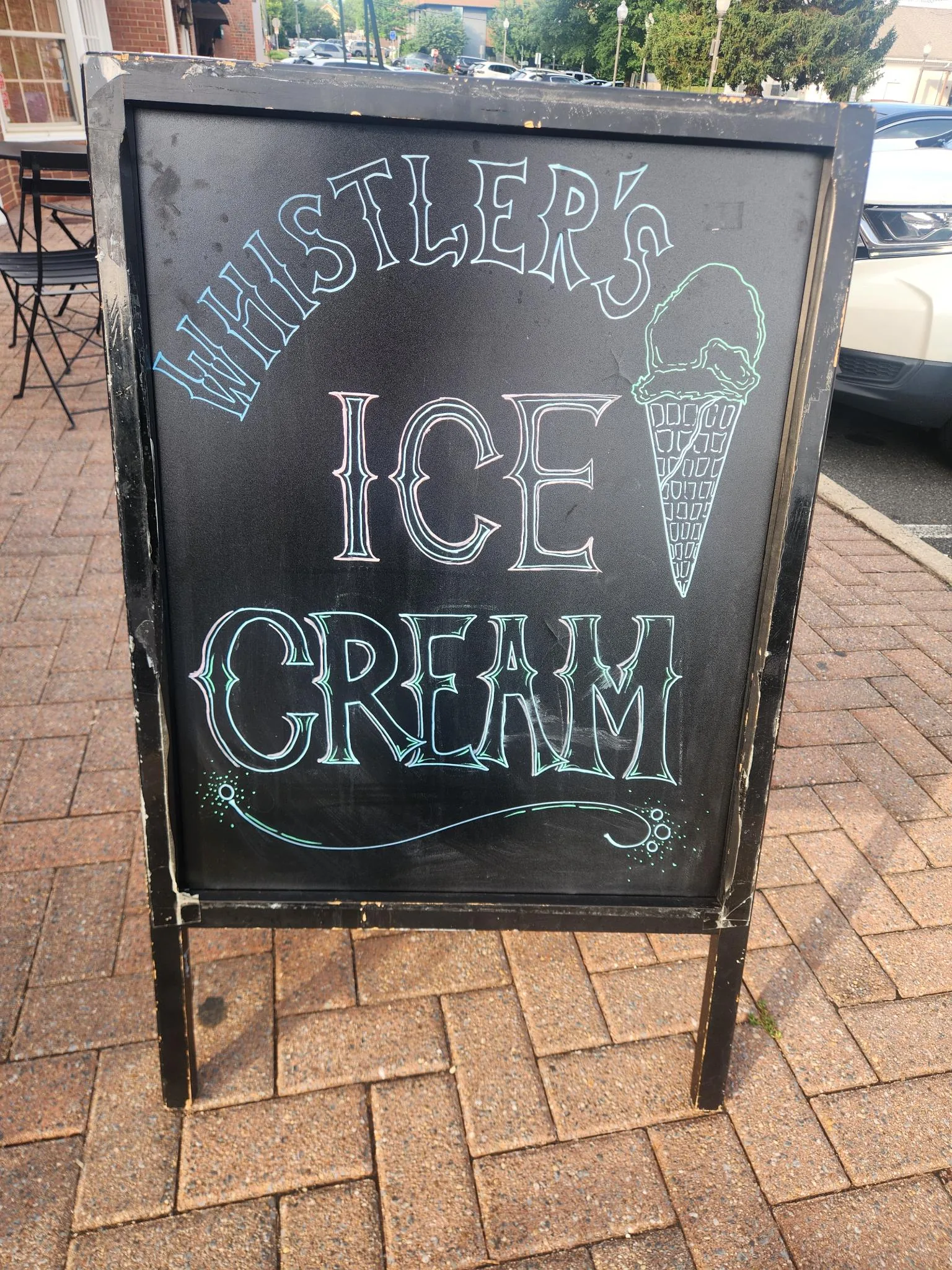 Sidewalk chalkboard reading Whistler's Ice Cream